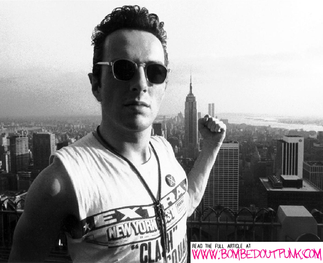 The Clash's Joe Strummer wearing a bowler instead of a tie