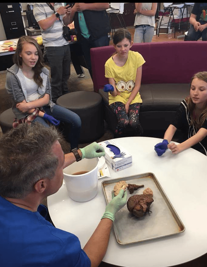 At Boys & Girls Club of Cheyenne, neurologist Dr. Tim Allen dissects a human brain